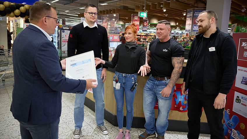Aufsichtsperson Norbert Kaiser von der BGHW verleiht den vier Ersthelfern ihre Urkunden.